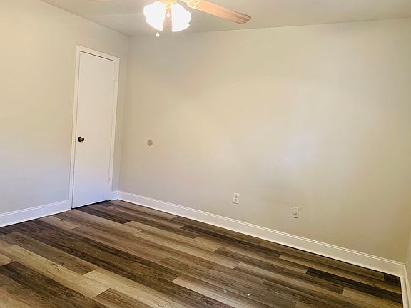 Master bedroom with a half bathroom