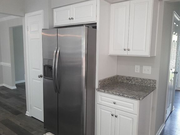 Kitchen w fridge and pantry