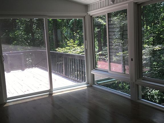 Sunroom and deck overlook wooded lot