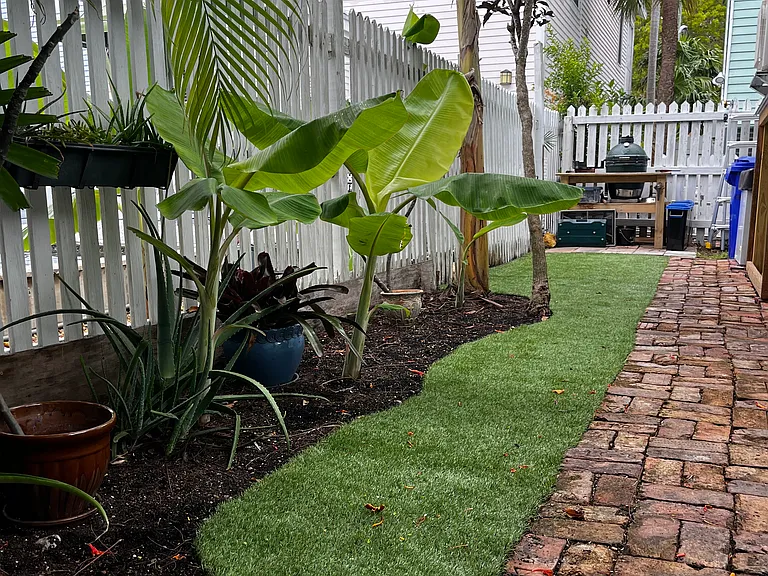 Mature landscaping and bricked pathways.