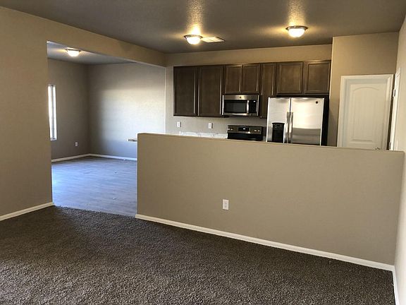 View from living room into kitchen and dinning nook to the left