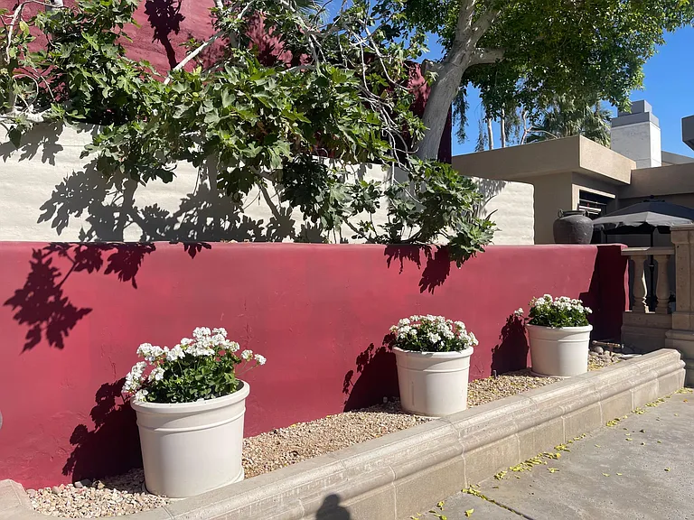 Triple garden walls and geraniums at giant chess patio