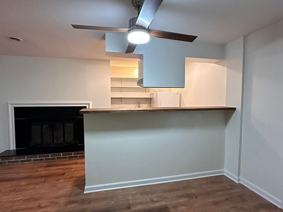 Galley kitchen with bar made from food-safe butcher block.