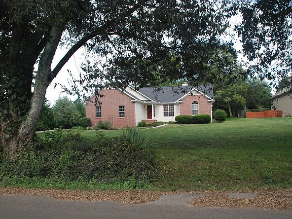 Large front yard with trees