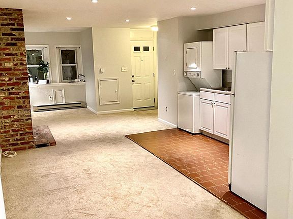 Living space with front "nook" perfect for office space. In front of 2 windows with good natural light.