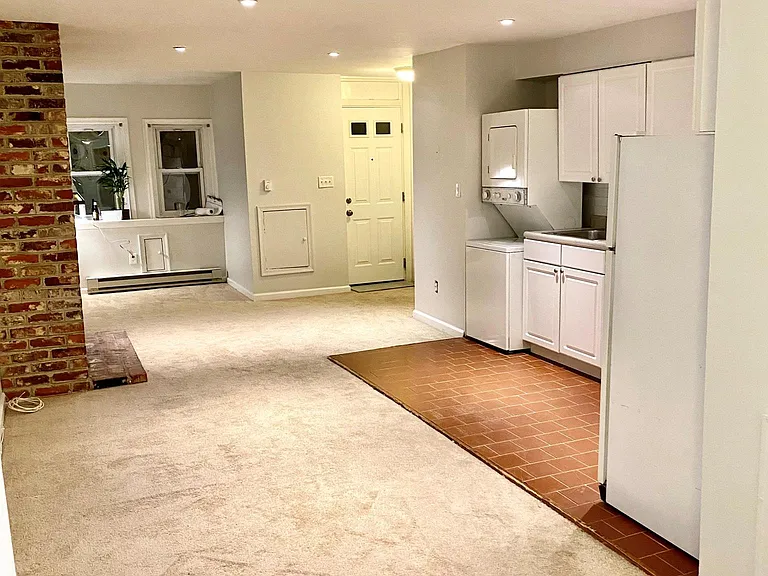 Living space with front "nook" perfect for office space. In front of 2 windows with good natural light.
