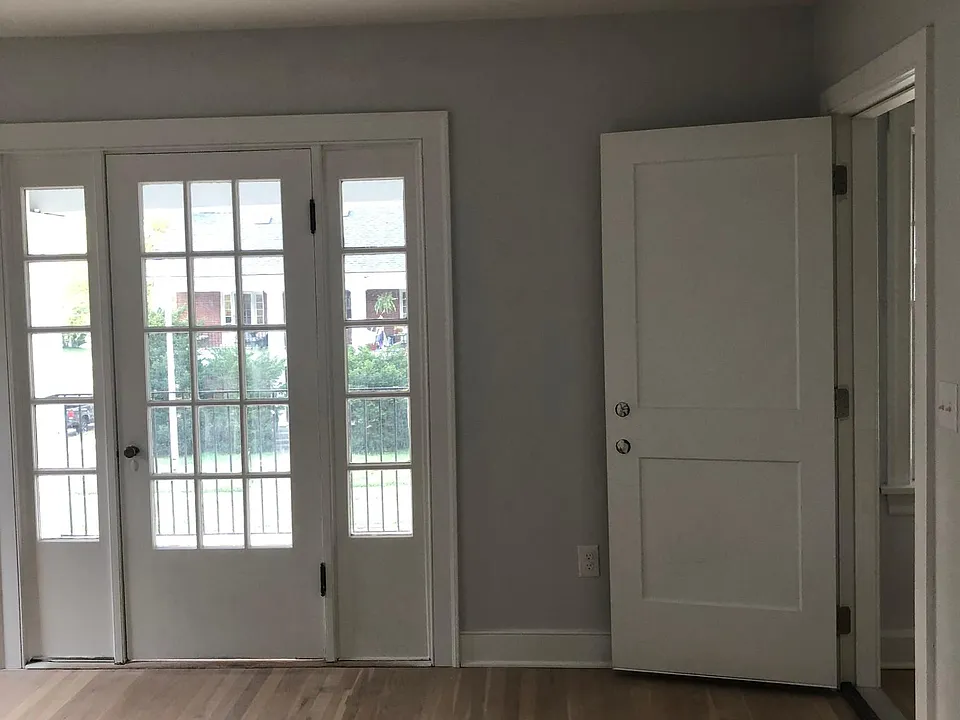 This is your first peek at the living room. The door to the right is the inside door from the hallway. The glass door leads to the front porch.