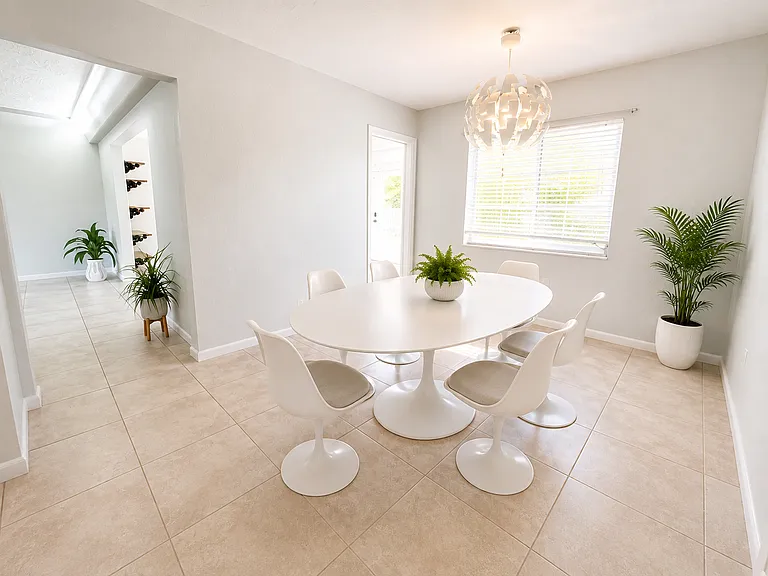 Kitchen Dining Area, facing Living Room and Sunroom (Staged with AI).