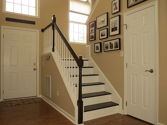 Foyer with refinished stairs