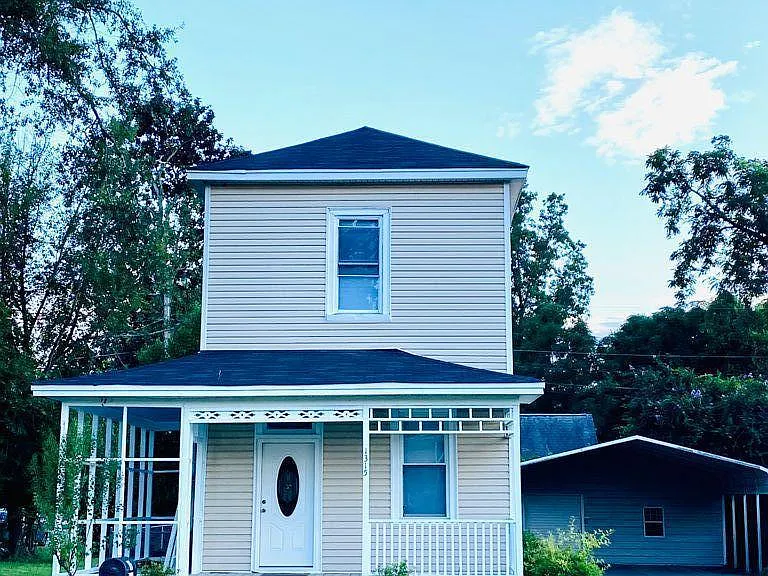 Historic Mill house with wrap around porch, long driveway and double covered carport