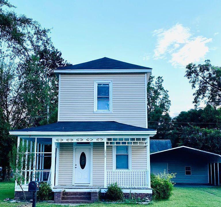 Historic Mill house with wrap around porch, long driveway and double covered carport