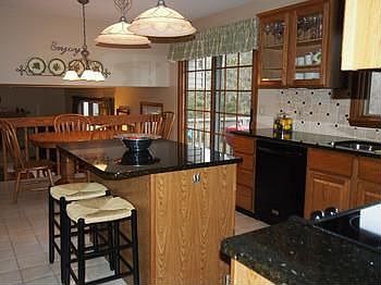 Wonderful kitchen updates include granite counters and ceramic backsplash.  Easy access to the back yard decks from the kitchen eating area.