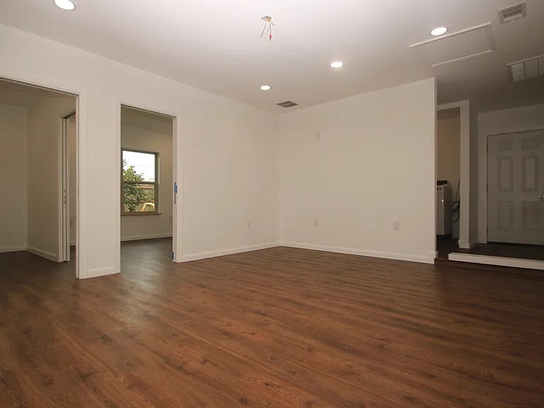Newly finished garage conversion, including entry room, utility room, and office/bedroom with large closet