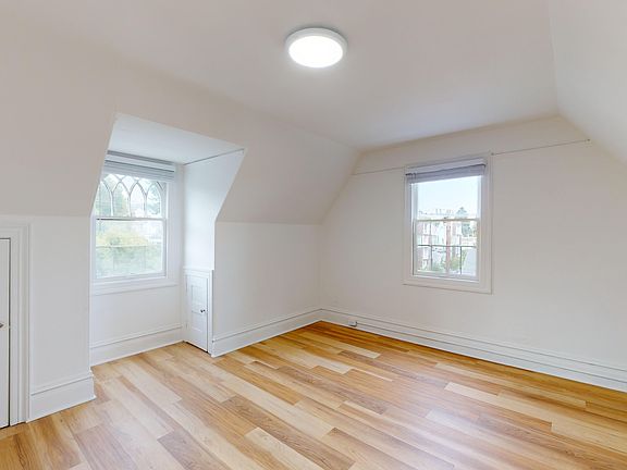 Well-lit room with a floor made of wood, adding a touch of warmth to the room