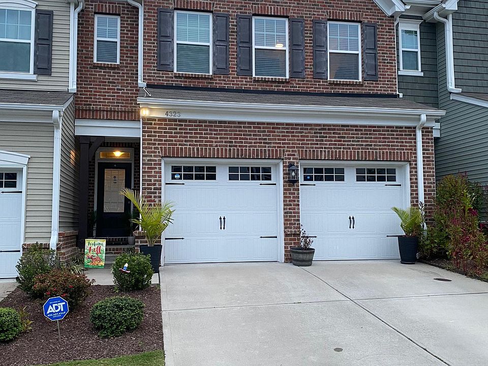 The outside of the home features beautiful brickwork, plenty of windows