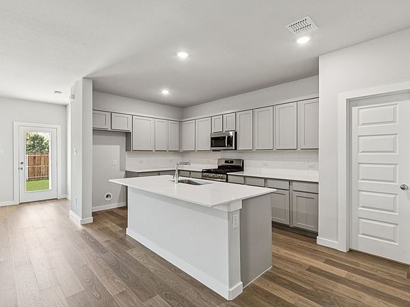 Kitchen in the Oscar home plan by Trophy Signature Homes - REPRESENTATIVE PHOTO