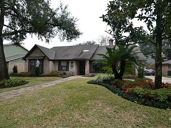 Enjoy another front view of this outstanding home from the driveway looking past the beautiful landscaping.