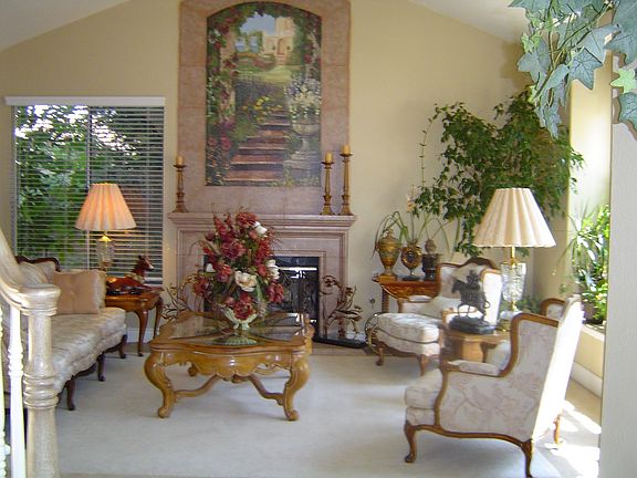 Custom painted Mural and fireplace add to the beauty of the formal livin room 