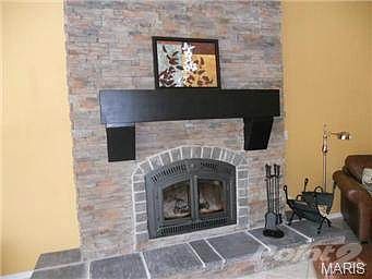 BEAUTIFUL STONE FACADE AND NAPOLEAN WOOD BURNING FIREPLACE.