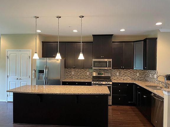 modern stainless steel appliances. nice granite breakfast island