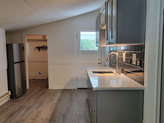 Looking into the adjoining laundry room with full size washer dryer hook ups. I will leave the washer for the new tenant. It is only a couple years old, however, it is not warrantied. Tenant to provide their own dryer, if desired.