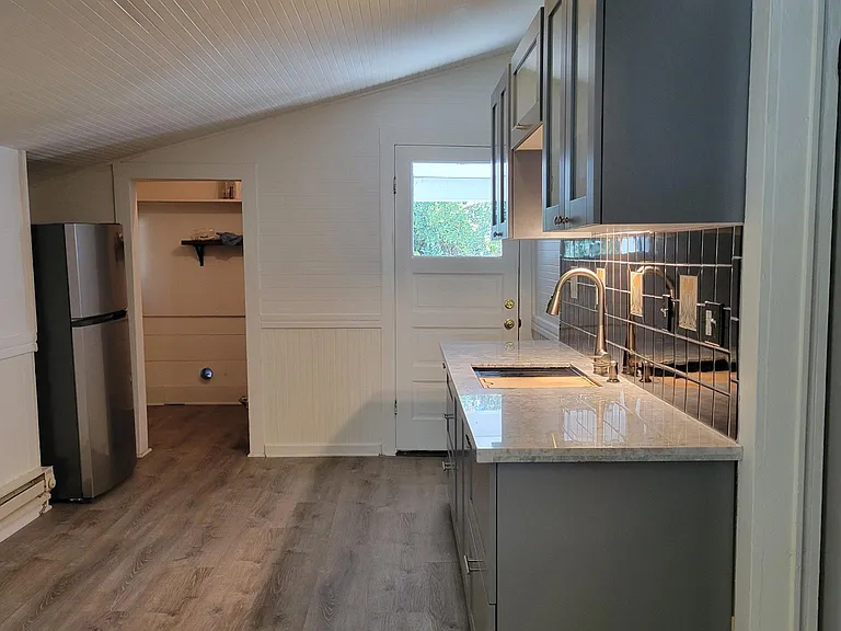 Looking into the adjoining laundry room with full size washer dryer hook ups. I will leave the washer for the new tenant. It is only a couple years old, however, it is not warrantied. Tenant to provide their own dryer, if desired.