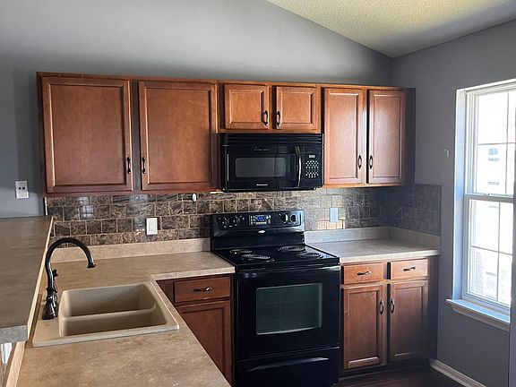 Kitchen includes all black appliance; stove, refrigerator, microwave, dishwasher, and garbage disposal