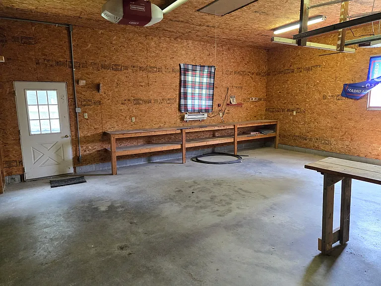 Workshop bench across the back of the 2 1/2 car garage. The garage is deep enough to park pickup trucks and SUV's.