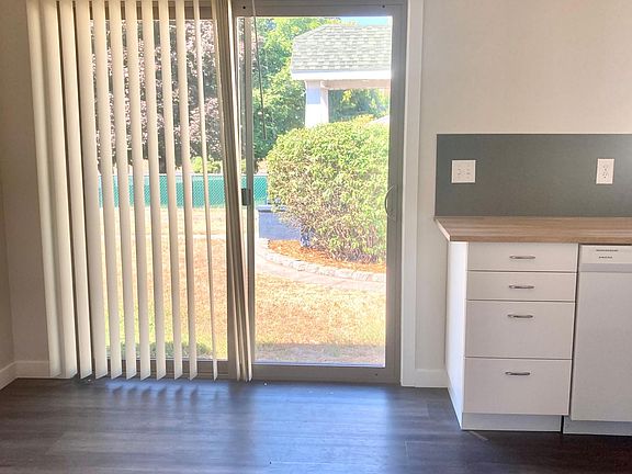 Sliding door to small patio next to kitchen with nice space for dining table.