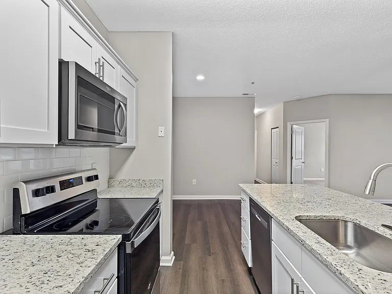 Newly renovated kitchens offer granite countertops and tile backsplash