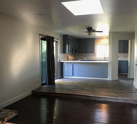 Great Room with step up to Dining area and kitchen. Lots of light in this room with two sliding glass doors to access the back yard. This is an end unit to the neighborhood. Lot's of extra space.