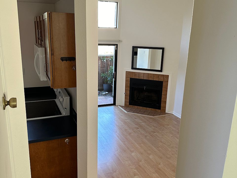 Spacious living room with vaulted ceilings leads to patio.