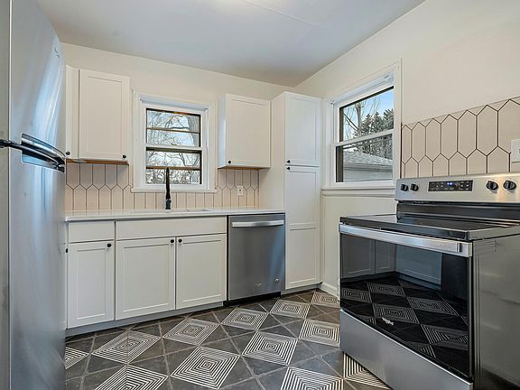 All new kitchen -- appliances, tile floor and backsplash, cabinets, lighting