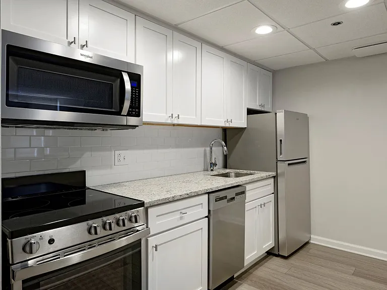 Renovated kitchen with granite countertops and stainless steel appliances