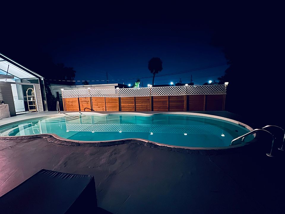 Unwind with a glass of wine by the pool and enjoy the city lights