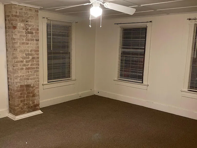 Master bedroom with tons of natural light, exposed brick and walk in closet. Has its own AC/Heat unit