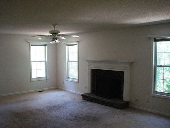 Oversized living room with working fireplace. Runs from front to back of house and is open to the ki