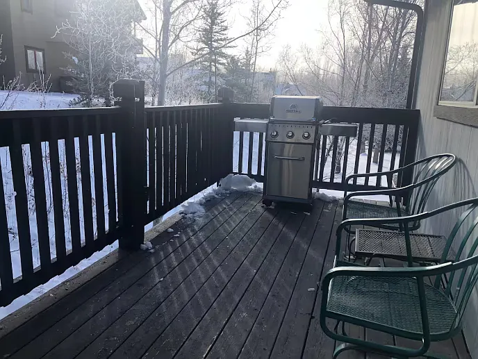 Deck and grill off dining room. In summer there is a large umbrella that goes over this area.