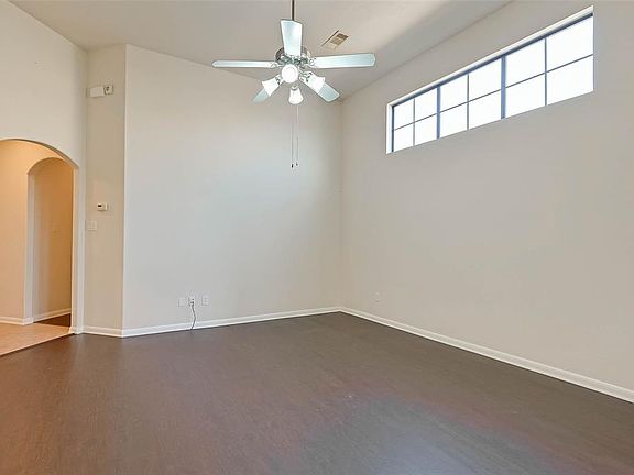 View of the Living Room, more windows for all of the wonderful sun light. Hallway leads to secondary bedrooms