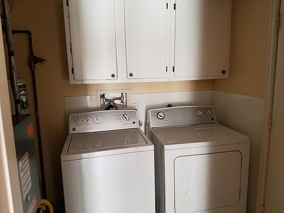 Laundry room with door to carport