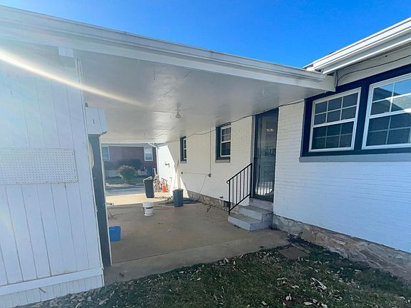 Back of house Photo. Back door and storage shed on left
