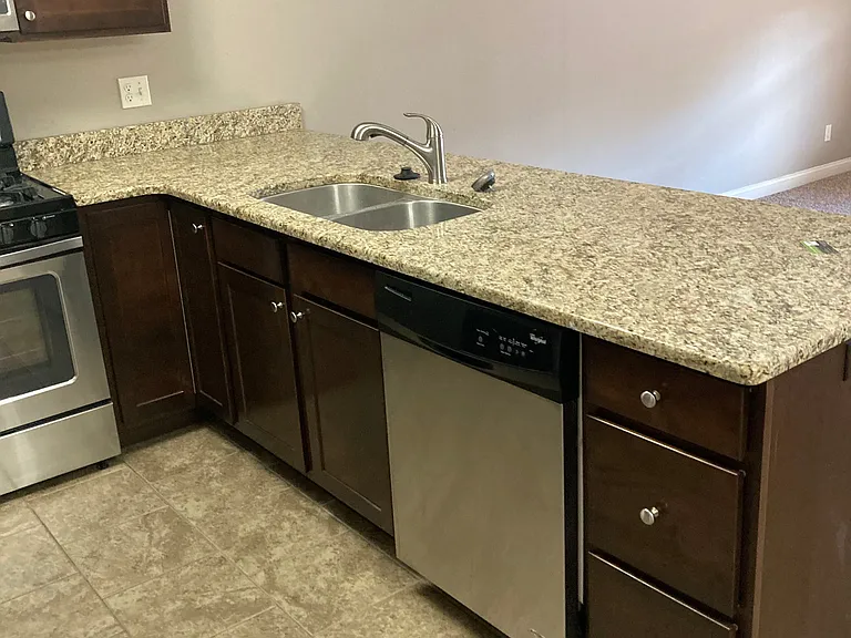 KITCHE WITH GRANITE COUNTERTOPS - OPEN TO LIVING ROOM AND DINING AREAS