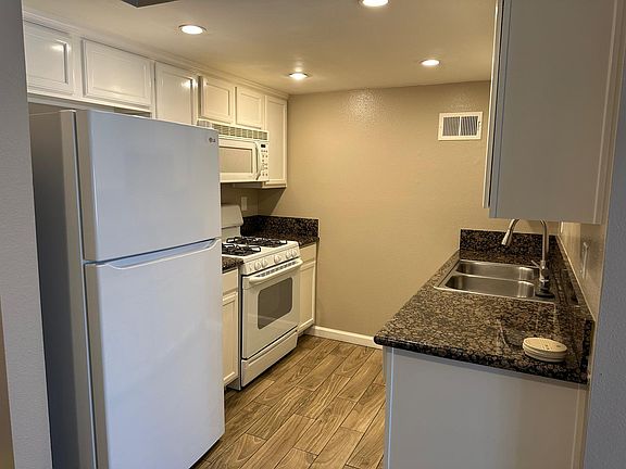 Kitchen with Refrigerator, Dishwasher, Cooking range and microwave.