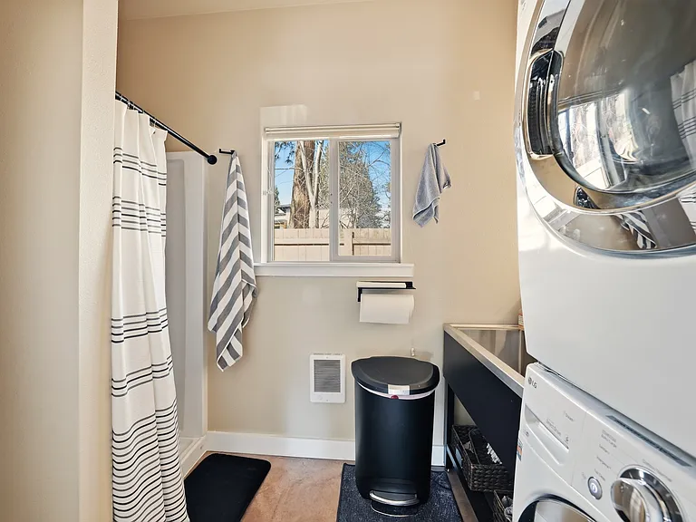This is the laundry room at the end of the hallway. Please note that the laundry area is reserved for the main floor tenants/owner, but this bathroom is available to all.