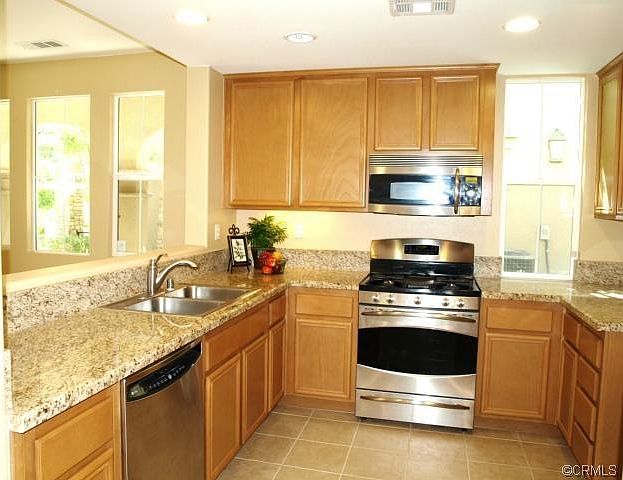 Upgraded kitchen with granite countertops, stainless steel a