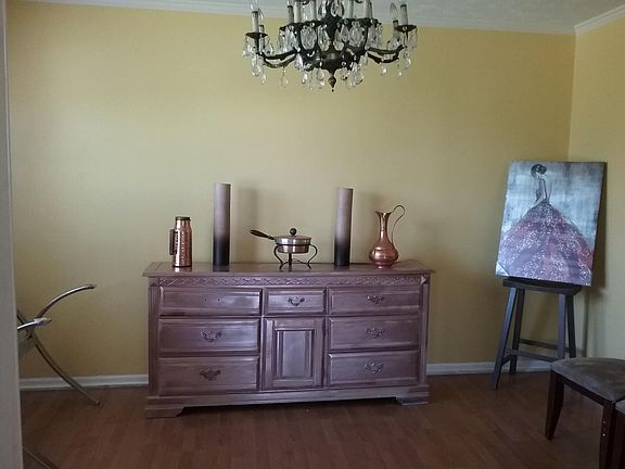 Formal Dining Room graced with a crystal chandelier and hardwood floors