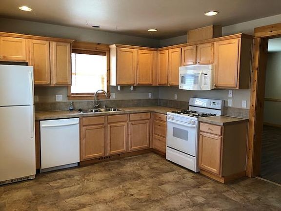 Light and bright kitchen with stove, microwave, refrigerator and dishwasher