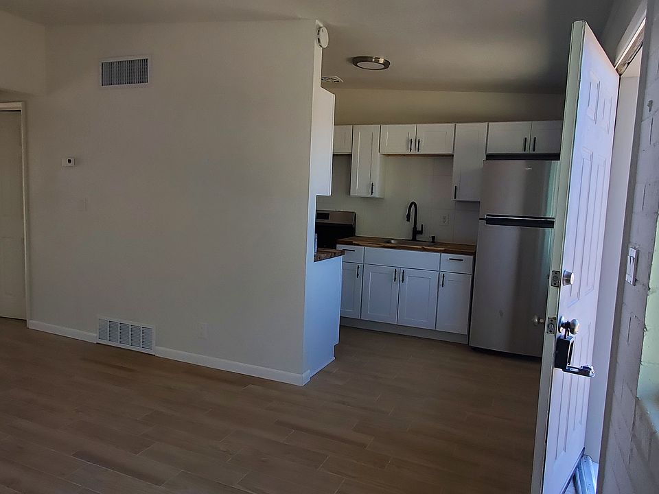 Living room with brand new wood floors and freshly painted.