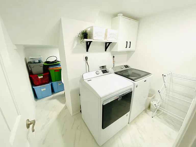 laundry room with storage on the back