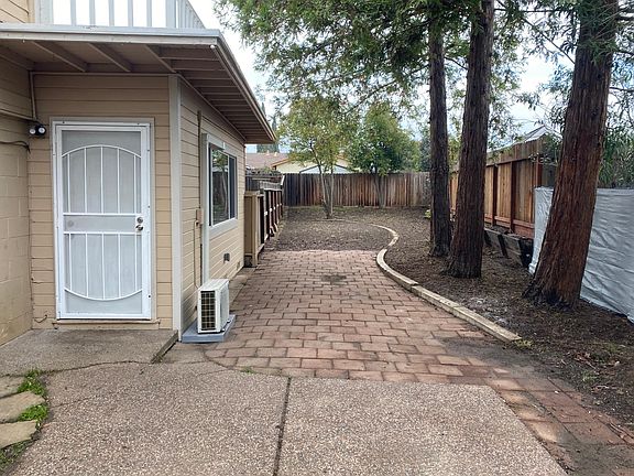 View of the front door and side yard